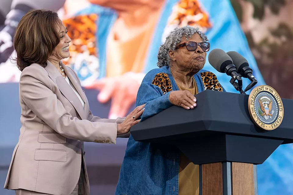 Opal Lee stand by Kamala Harris while giving a speech